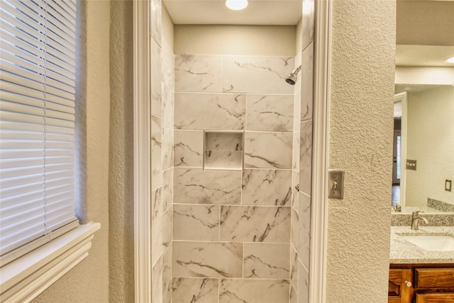 112 Woodcrest St, Weatherford, TX 76087 - full bathroom featuring a textured wall, vanity, and tiled shower