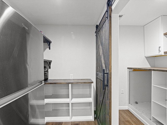 175 Clover Ln, Decatur, TX 76234 - walk in closet with a barn door and wood finished floors