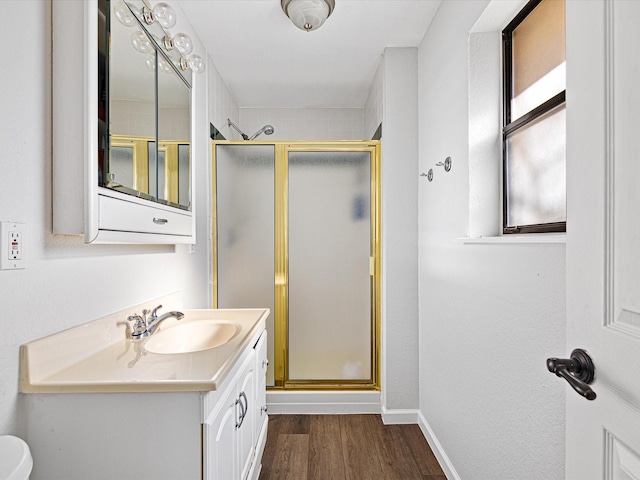 175 Clover Ln, Decatur, TX 76234 - bathroom with baseboards, wood finished floors, a stall shower, and vanity