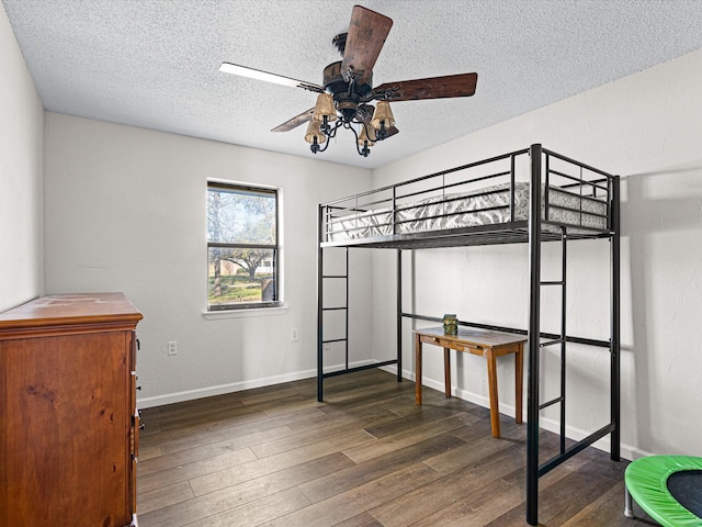 175 Clover Ln, Decatur, TX 76234 - unfurnished bedroom featuring baseboards, a textured ceiling, and wood finished floors