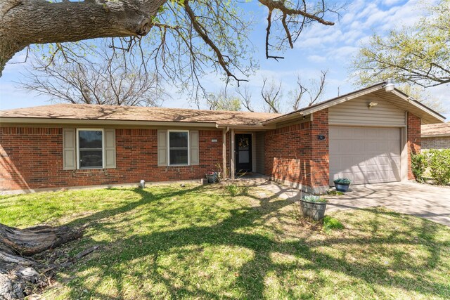 single story home featuring brick siding, a garage, and driveway