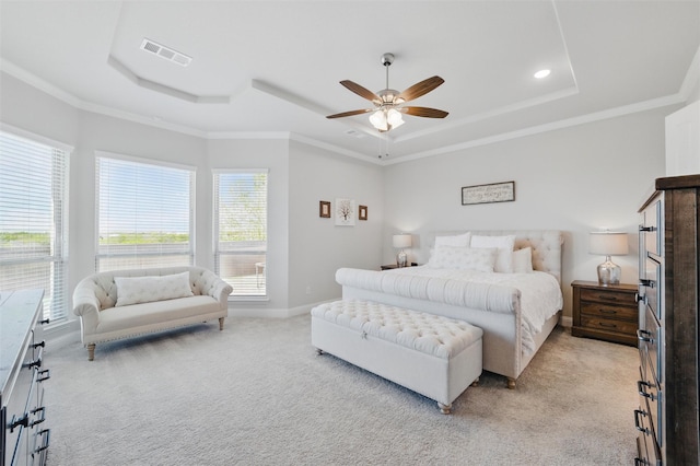 bedroom featuring visible vents, baseboards, ornamental molding, a raised ceiling, and light colored carpet