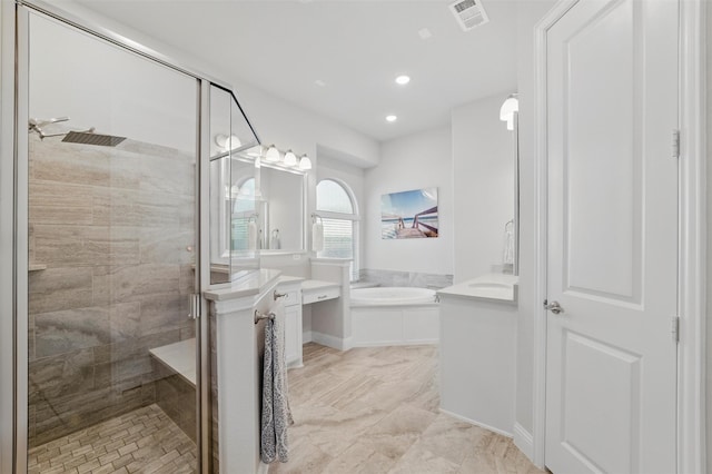 bathroom with a stall shower, vanity, a bath, visible vents, and recessed lighting