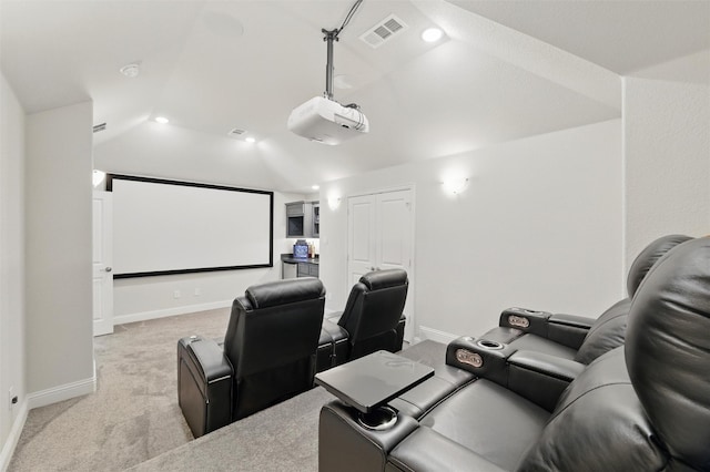cinema featuring light colored carpet, visible vents, lofted ceiling, and baseboards
