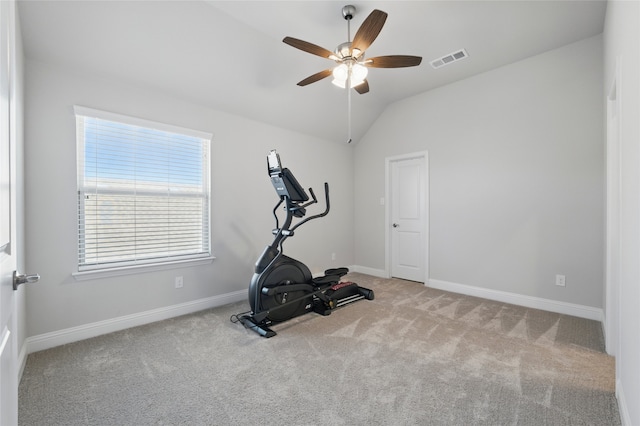 exercise room with a ceiling fan, carpet, lofted ceiling, and visible vents