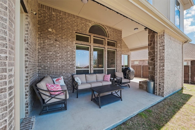view of patio with an outdoor hangout area, fence, and a grill