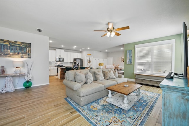 6028 Bowie Ct, Providence Village, TX 76227 - living room featuring a ceiling fan, baseboards, light wood-type flooring, and recessed lighting