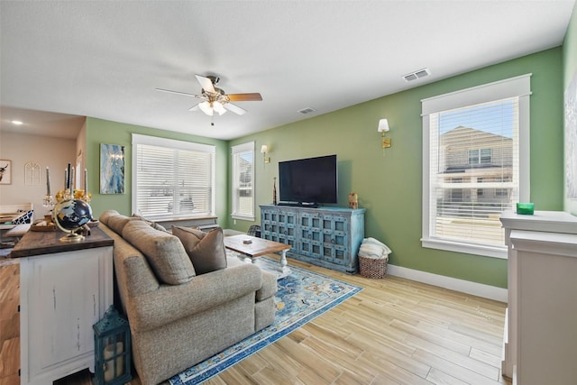 6028 Bowie Ct, Providence Village, TX 76227 - living area with ceiling fan, baseboards, and light wood-style floors