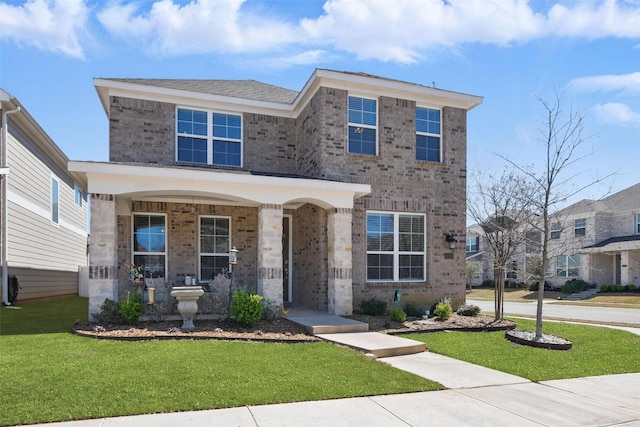 6028 Bowie Ct, Providence Village, TX 76227 - traditional home featuring a front yard, brick siding, and a porch