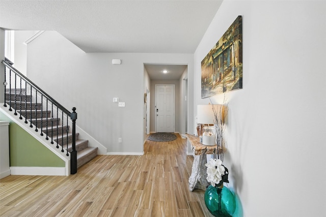 6028 Bowie Ct, Providence Village, TX 76227 - entryway featuring light wood finished floors, stairs, and baseboards