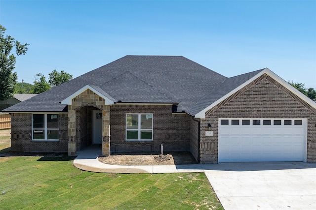 719 Cobblestone Cir, Mabank, TX 75147 - view of front of property with a garage, a front lawn, driveway, brick siding, and roof with shingles