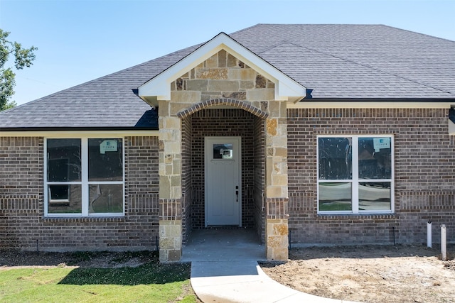 719 Cobblestone Cir, Mabank, TX 75147 - view of exterior entry with brick siding and roof with shingles