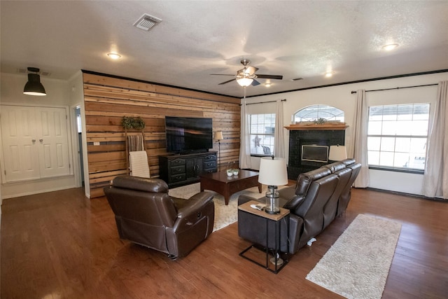 514 Preston Dr, Pottsboro, TX 75076 - living room featuring a textured ceiling, visible vents, crown molding, ceiling fan, and dark wood-type flooring