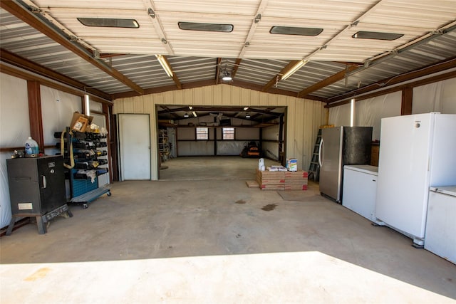 514 Preston Dr, Pottsboro, TX 75076 - garage featuring freestanding refrigerator, refrigerator, and metal wall