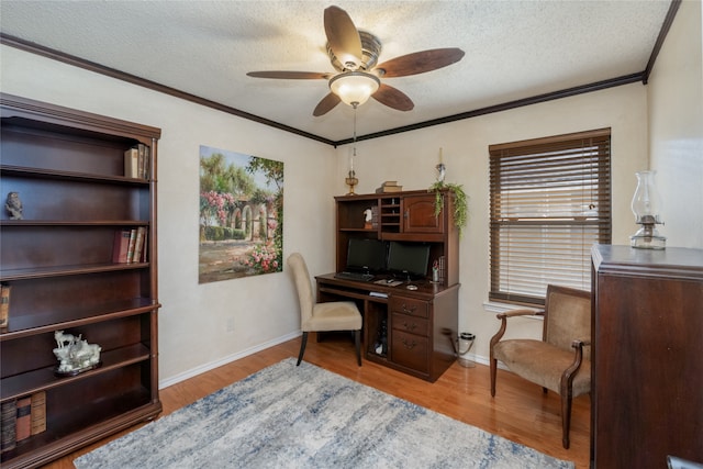 home office featuring baseboards, crown molding, ceiling fan, and wood finished floors