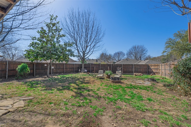 view of yard with an outdoor fire pit and a fenced backyard