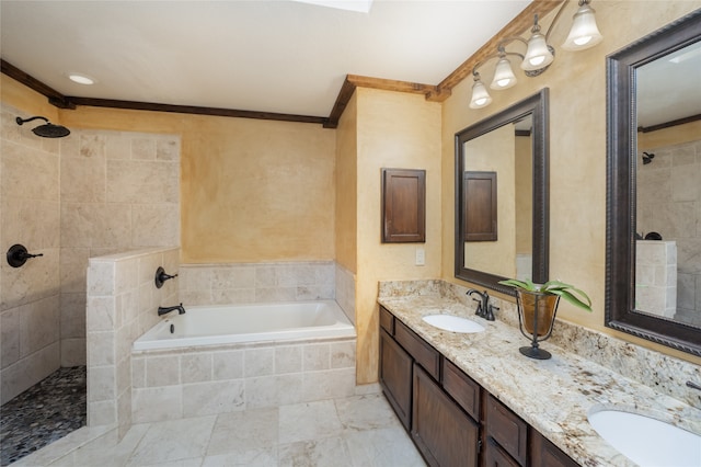 bathroom with a sink, ornamental molding, and tiled shower