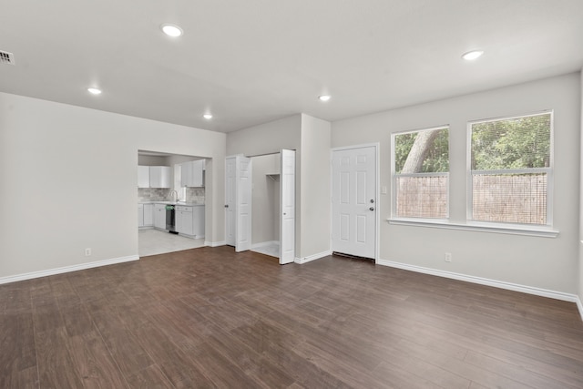 4601 Virginia Ln, Fort Worth, TX 76103 - unfurnished living room with dark wood finished floors, baseboards, recessed lighting, and a sink