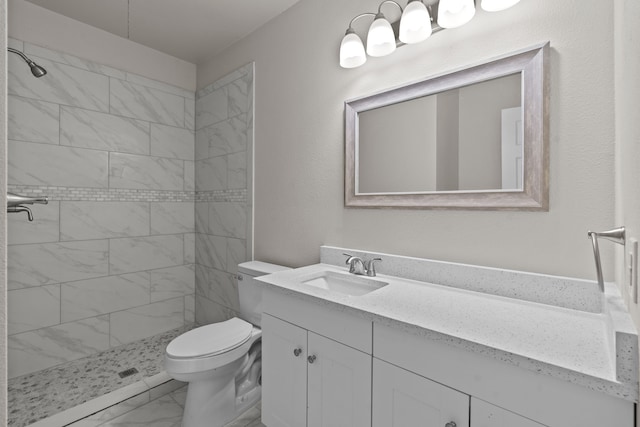 4601 Virginia Ln, Fort Worth, TX 76103 - bathroom with vanity, marble look tiles, toilet, and tiled shower