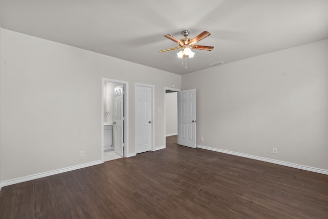 4601 Virginia Ln, Fort Worth, TX 76103 - unfurnished bedroom with dark wood-style floors, baseboards, ensuite bath, and ceiling fan