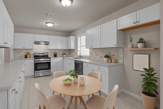 4601 Virginia Ln, Fort Worth, TX 76103 - kitchen featuring stainless steel range with gas cooktop, dishwasher, under cabinet range hood, and backsplash