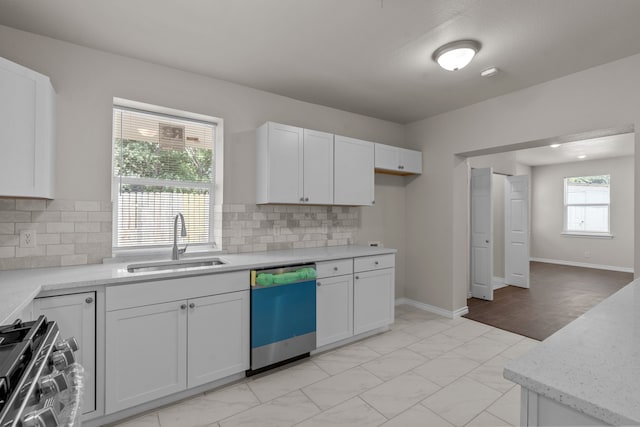 4601 Virginia Ln, Fort Worth, TX 76103 - kitchen with dishwashing machine, a sink, range, white cabinets, and light marble finish floors