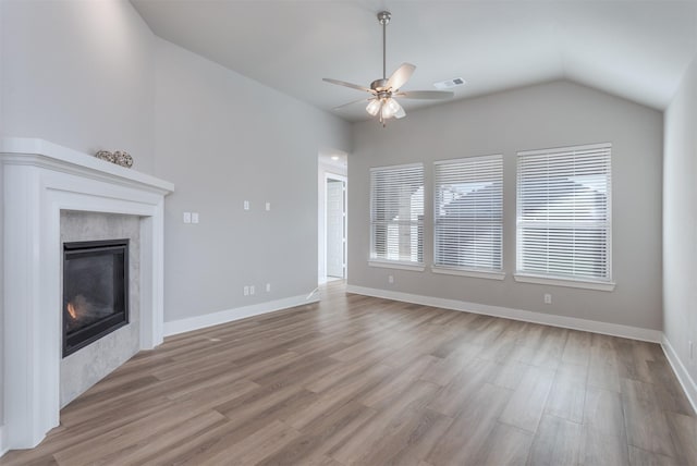 1916 Pelham Dr, Aubrey, TX 76227 - unfurnished living room with a high end fireplace, ceiling fan, lofted ceiling, wood finished floors, and baseboards