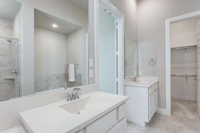 1916 Pelham Dr, Aubrey, TX 76227 - bathroom with a spacious closet, two vanities, tiled shower, and tile patterned flooring