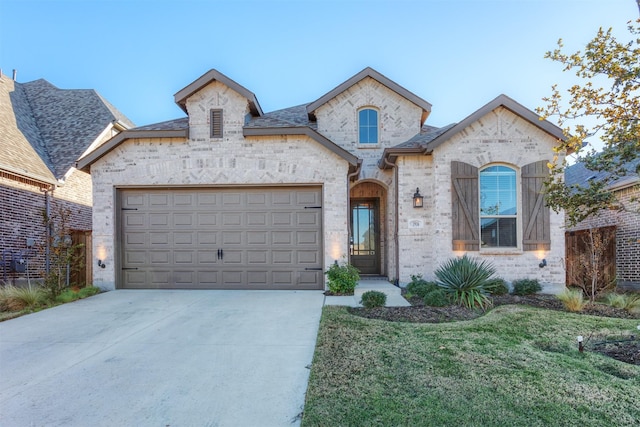 1916 Pelham Dr, Aubrey, TX 76227 - french country inspired facade with driveway, a front lawn, a garage, and stone siding
