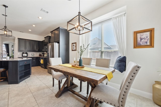 4600 Periwinkle Dr, Mansfield, TX 76063 - dining room featuring a chandelier, light tile patterned floors, recessed lighting, arched walkways, and baseboards