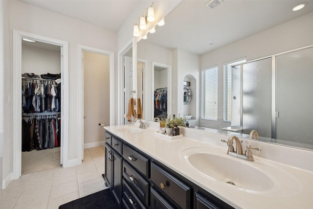 4600 Periwinkle Dr, Mansfield, TX 76063 - bathroom with tile patterned flooring, double vanity, a stall shower, baseboards, and a spacious closet