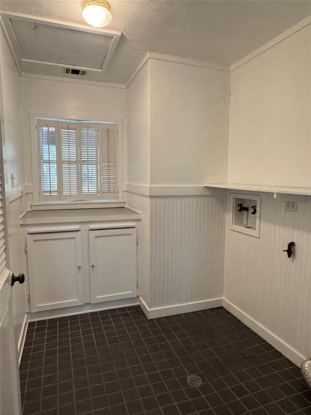 laundry area featuring laundry area, washer hookup, wainscoting, and visible vents