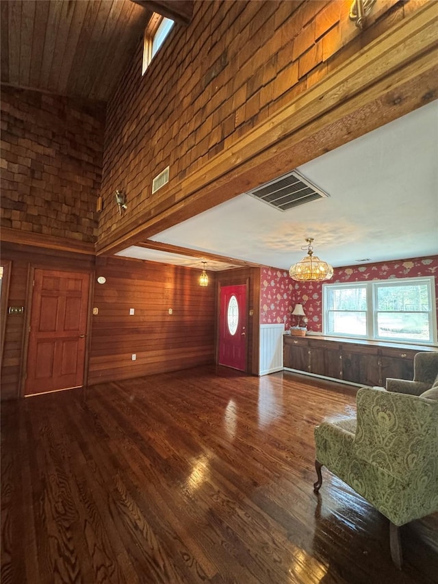 living room featuring a chandelier, visible vents, and wood finished floors