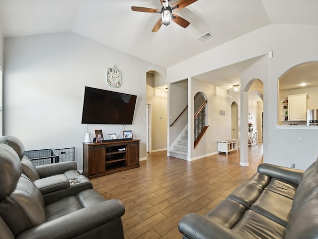 4013 Hollow Lake Rd, Fort Worth, TX 76262 - living area with arched walkways, lofted ceiling, ceiling fan, stairs, and wood finished floors