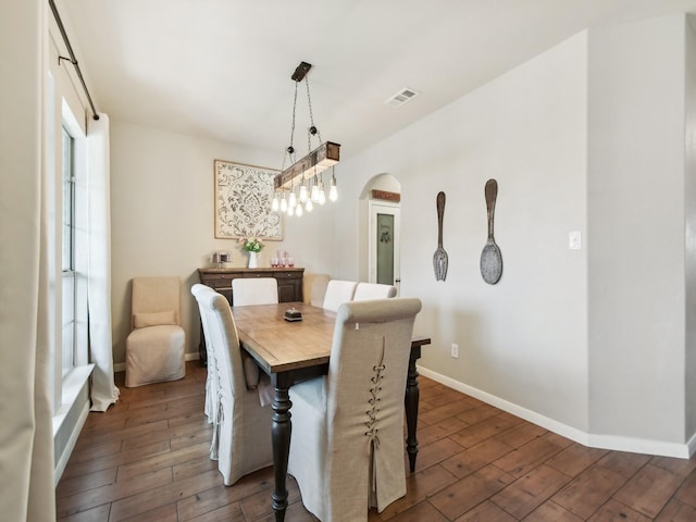 4013 Hollow Lake Rd, Fort Worth, TX 76262 - dining space featuring arched walkways, dark wood-style flooring, baseboards, and visible vents