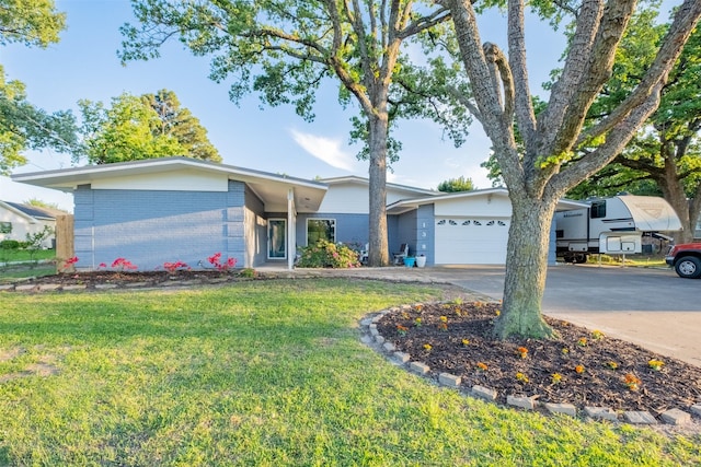 138 Hideaway Ln E, Hideaway, TX 75771 - ranch-style house featuring concrete driveway, a garage, a front lawn, and brick siding