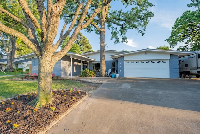 138 Hideaway Ln E, Hideaway, TX 75771 - view of front of house with concrete driveway, brick siding, and a garage