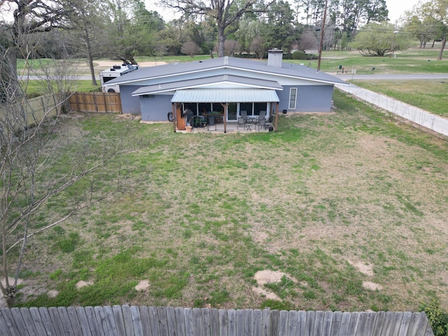 138 Hideaway Ln E, Hideaway, TX 75771 - exterior space featuring a patio area, a chimney, a lawn, and a fenced backyard