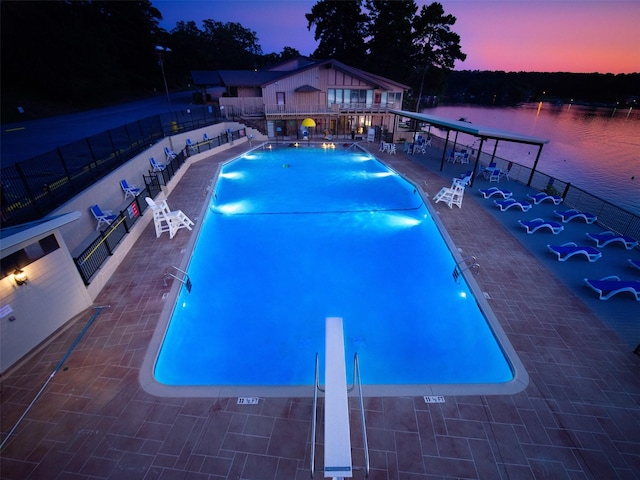 138 Hideaway Ln E, Hideaway, TX 75771 - pool at dusk featuring fence, a water view, a patio, and a community pool