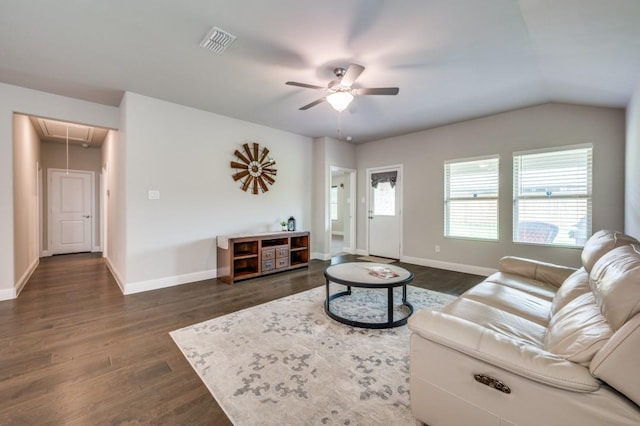 living room with dark wood-style flooring, attic access, a ceiling fan, baseboards, and visible vents