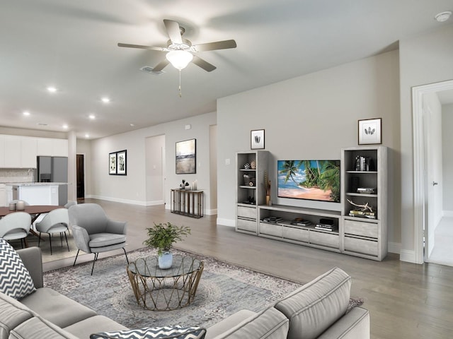living area with recessed lighting, ceiling fan, visible vents, and wood finished floors