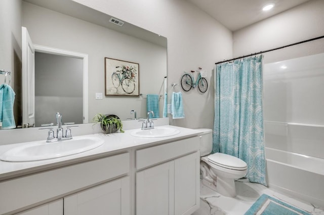 bathroom with a sink, toilet, double vanity, and visible vents