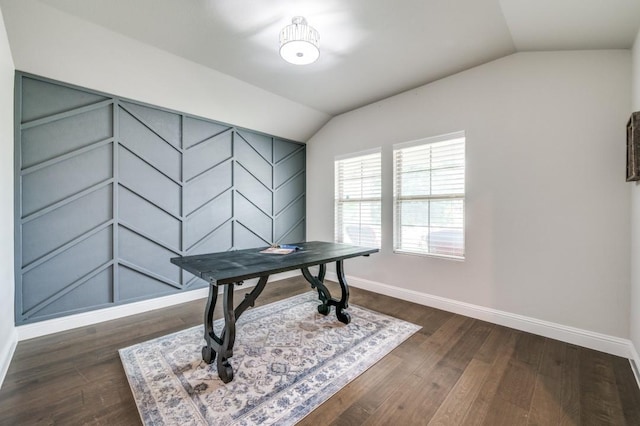 office space featuring baseboards, vaulted ceiling, and dark wood-type flooring