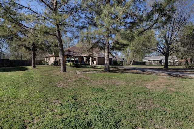 1009 Division St, Greenville, TX 75401 - view of yard featuring driveway and a garage