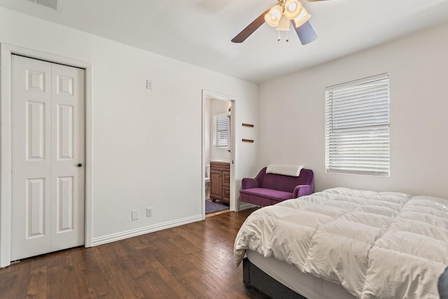bedroom featuring ensuite bath, hardwood / wood-style flooring, baseboards, and a closet