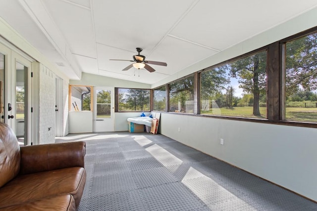 unfurnished sunroom featuring ceiling fan