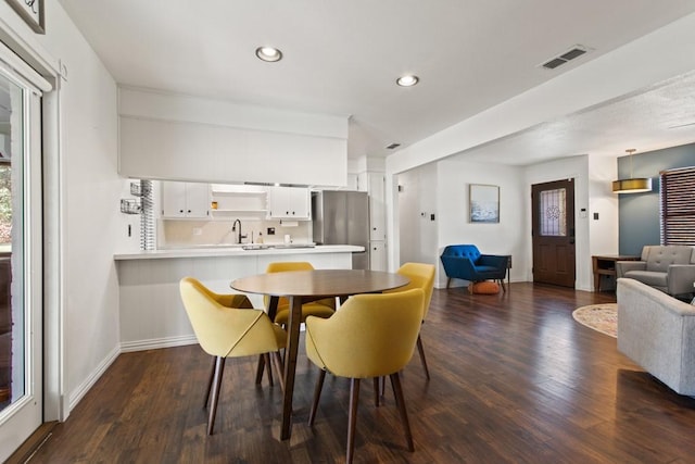 dining room featuring baseboards, visible vents, recessed lighting, and dark wood-type flooring