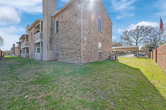 1700 Amelia Ct Unit 312, Plano, TX 75075 - back of house featuring brick siding, a carport, central AC unit, and a chimney