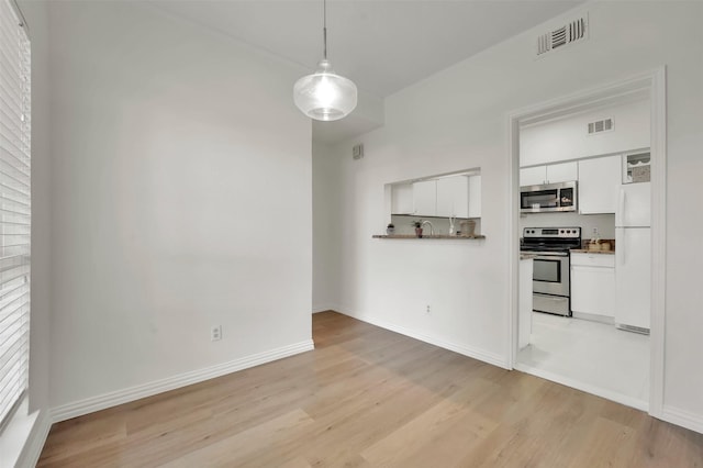 1700 Amelia Ct Unit 312, Plano, TX 75075 - unfurnished dining area with light wood-style flooring and baseboards
