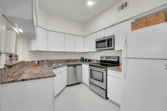 1700 Amelia Ct Unit 312, Plano, TX 75075 - kitchen with appliances with stainless steel finishes, a sink, white cabinetry, light stone countertops, and recessed lighting